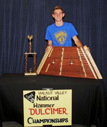 3rd Place Hammer Dulcimer Winner, Ben Haguewood, with Trophy and Prize Hammer Dulcimer