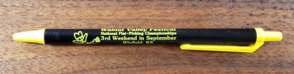 Black and Yellow pen with Walnut Valley Festival's "Fesity" logo and contact information