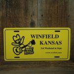 Yellow Car Tag, reads "Winfield, Kansas, 3rd Weekend in Sept., www.wvfest.com"