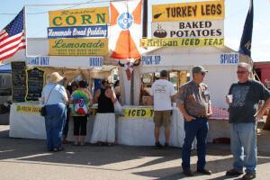 Roasted corn, turkey legs, and other foods for sale on the festival midway