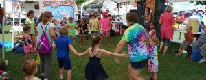 Kids holding hands and dancing to music