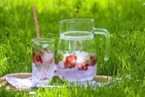 Iced strawberry water in cup and pitcher