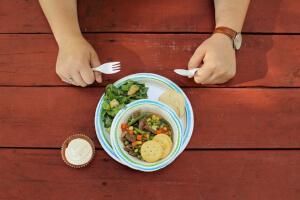 Person at picnic table ready to eat